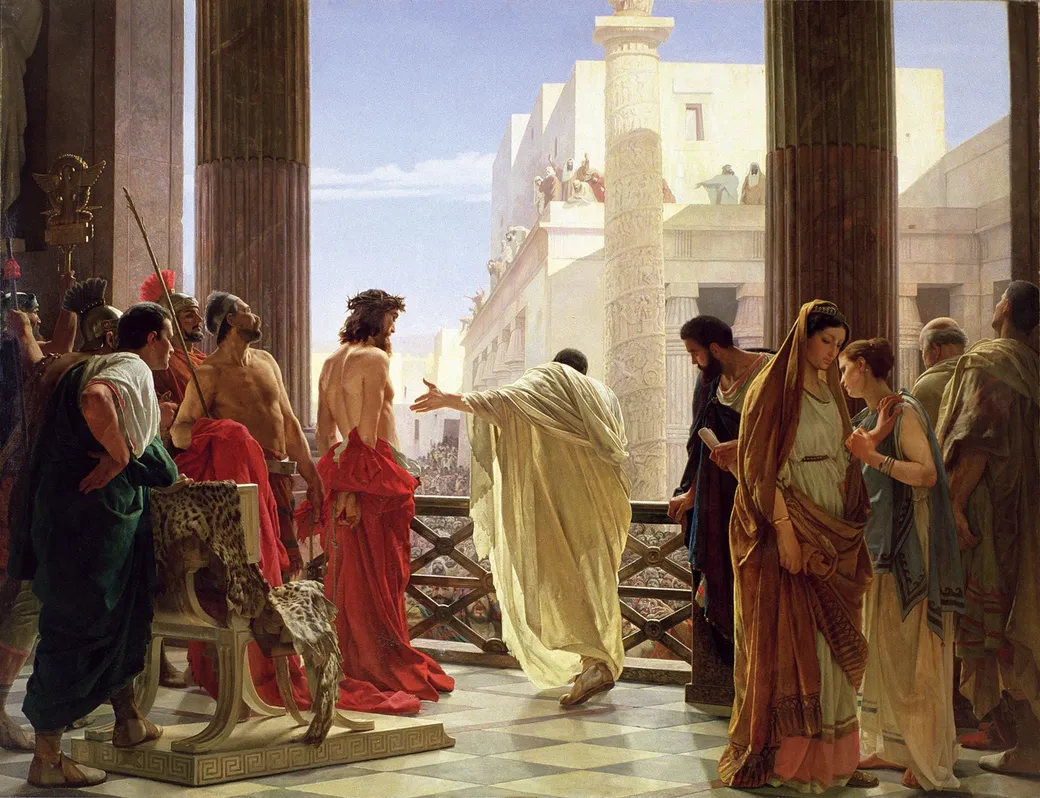 Oil painting of a sunlit balcony between tall marble columns. Pilate, in a pale cream robe with his back to us, stretches one arm toward Jesus, who stands beside him wearing a crown of thorns, bare to the waist, his hands bound behind him and a red robe around his hips. Below the railing a dense crowd fills the street, and more people gesture from a rooftop across the way. Roman soldiers, a gilded eagle standard and an empty chair draped in a leopard skin are on the left; on the right, a woman in a gold mantle looks down while another woman leans toward her.
